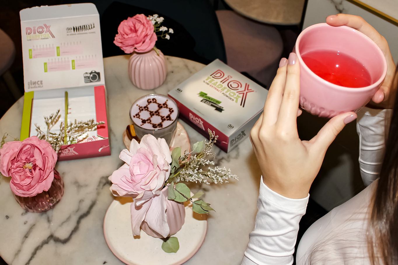 Diox Detox Tea product box and sachets lifestyle photo